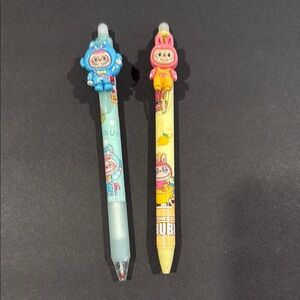 Labubu dressed in a Stitch costume and a yellow Labubu Gel erasable pen